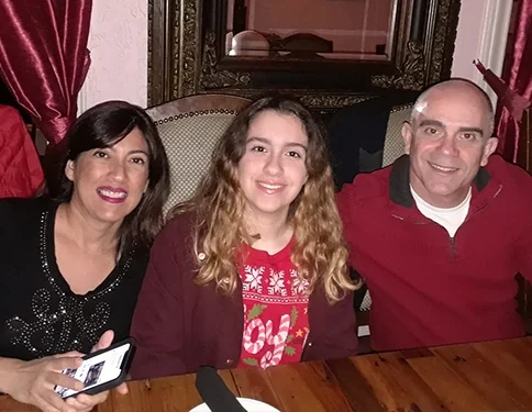 Dr. Perez with his wife and daughter at a family dinner.